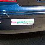 Pink and green on white vinyl Love Peace Beauty bumper sticker on car