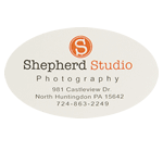 Orange and black logo and address on white oval Shepard Studio Photography custom roll label sample
