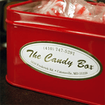 Red tin candy box with white and gold foil product label