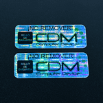 Rectangle label with CDM logo printed on "Secured - Void If Removed" material with Black ink.