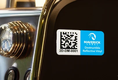 Tamper-proof label with QR code displayed on a reflective surface.